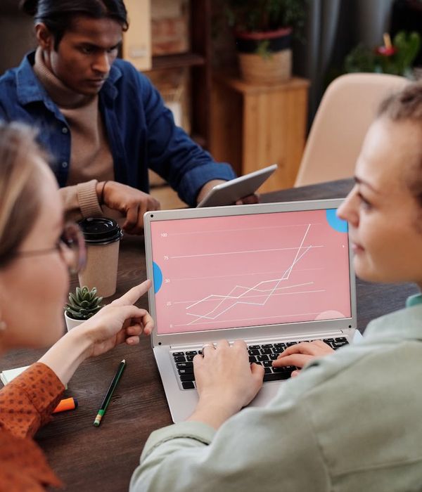 Modern office environment with team members collaborating on data analysis