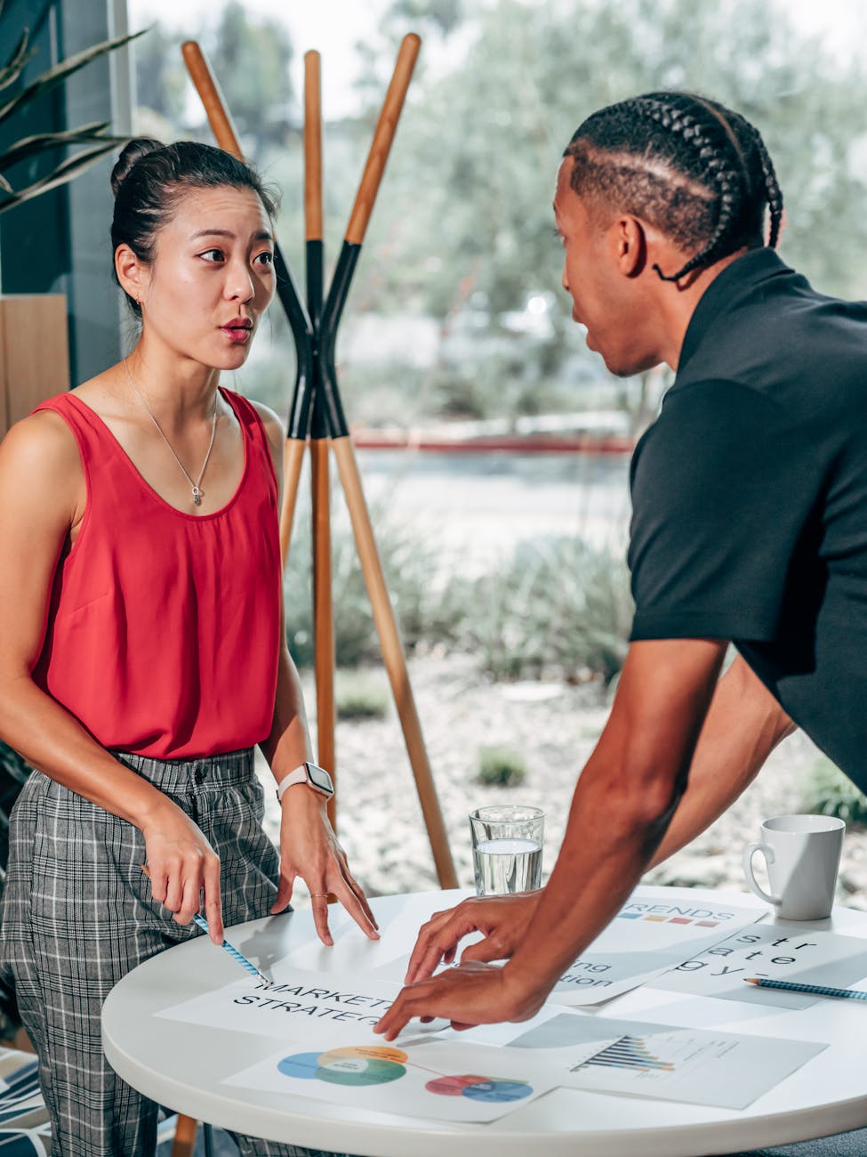 Professional team analyzing complex HR data on multiple screens with charts